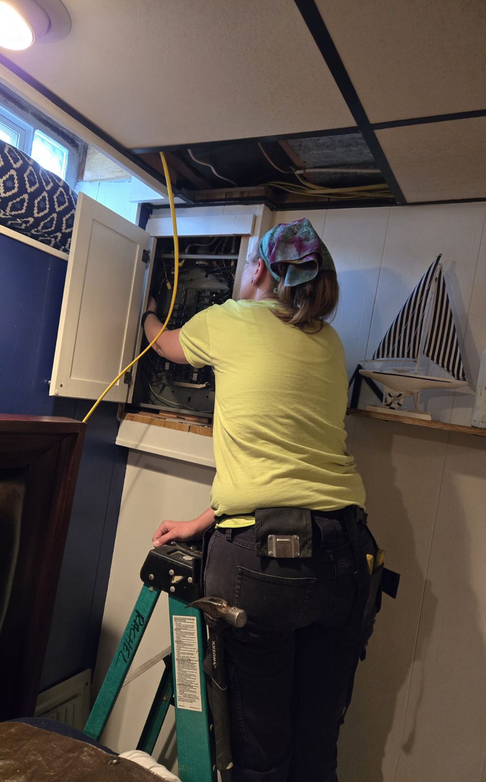 Energize Electric electrician running new wire into a residential electrical panel